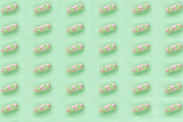 Capsules with icons like and heart in blue, with green background.