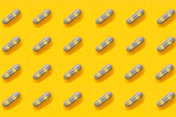 Capsules with icons like and heart in blue, with yellow background.
