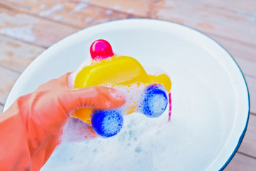 washing toy car with soap and water to disinfect it