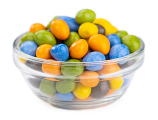 Chocolate coated peanuts isolated on white