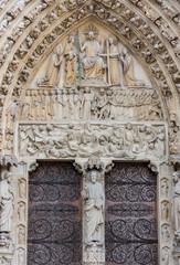 Fototapeta na wymiar Statue on the door of Notre-Dame de Paris before the big fire, a medieval Catholic cathedral on the Ile de la Cite in the 4th arrondissement of Paris.
