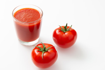 glass of tomato juice and tomato