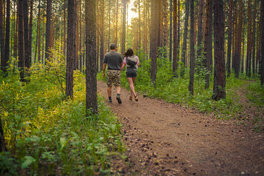 Two People Walking In The Forest