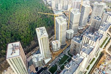 aerial topdown view of large construction site on the outskirts of the city near the park