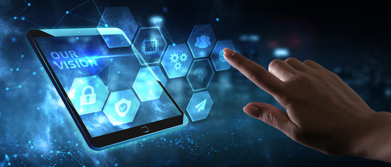 Business, Technology, Internet and network concept. Young businessman working on a virtual screen of the future and sees the inscription: Our vision © putilov_denis