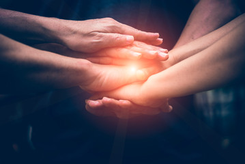 Close up of teamwork putting their hands together show the sign  of full power good connection for...