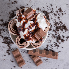 Ice cream roll with chocolate and whipped cream