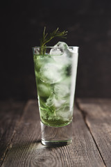 Sweet tequila based green cocktail with tarragon and rosemary. Selective focus. Shallow depth of field.