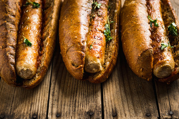 Tasty fresh hot dogs with grilled sausage on the rustic background. Selective focus. Shallow depth of field.