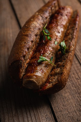 Tasty fresh hot dogs with grilled sausage on the rustic background. Selective focus. Shallow depth of field.