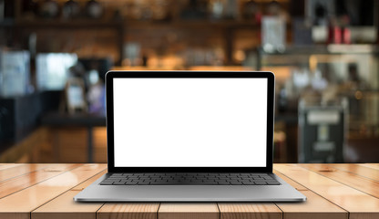 Laptop with blank screen on wooden table