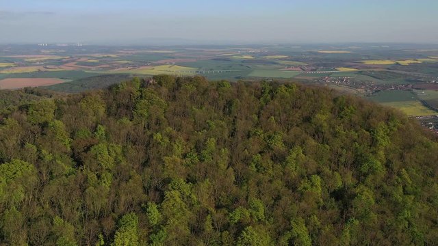 Flight over forested hill revealing countryside around Nitra city