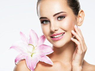 Beauty  face of  young beautiful smiling woman with flower