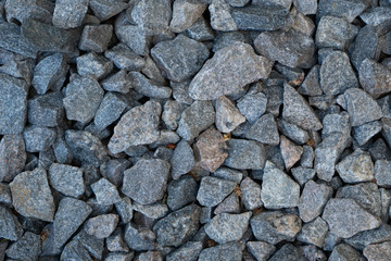 Large parts of crushed stones on the ground texture