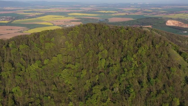 Flight over forested hill revealing countryside around Nitra city