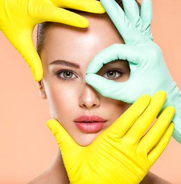 Face Skin Check Before Plastic Surgery. Beautician Touching Young Woman Face. Doctor In Medicine Gloves Checks A Skin Before Plastic Surgery. Beauty Treatments.