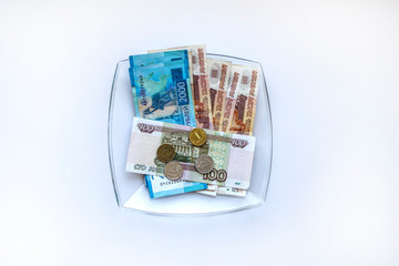 Russian rubles lying on a glass plate on a white background. Salary issue. Money.