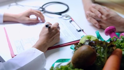 Nutritionist giving consultation to patient with healthy fruit and vegetable, Right nutrition and diet concept