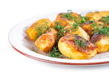 Fried fresh potatos and dill on a plate isolated on a white background