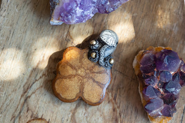 Beautiful ayhuasca root pendant on wooden backround with amethyst druses