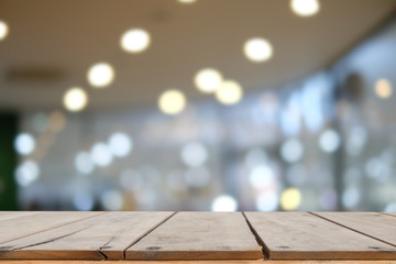 Empty brown wooden table and blur background of resturant, can be used for montage or display your products