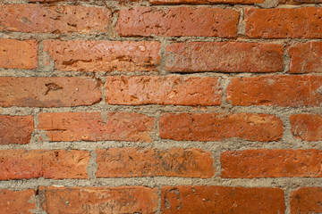 Old brick wall, old texture of red stone blocks closeup