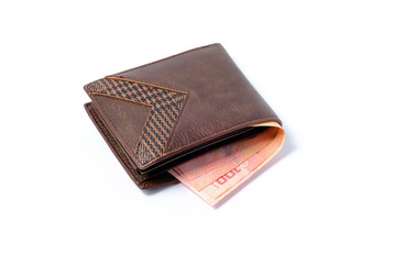 Side view of isolated genuine leather brown with many banknotes on white background.