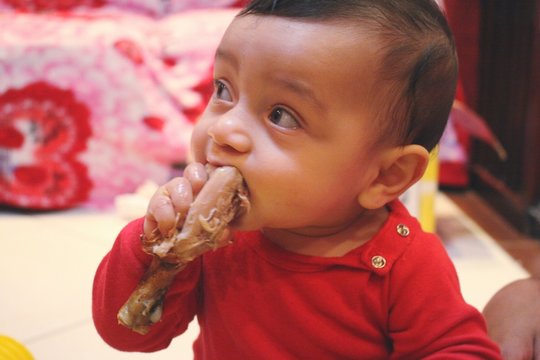 Close-up Of Cute Boy Eating Chicken