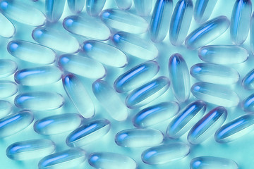 Close up pills on a blue background. Transparent pills. Medicine. Healthcare.