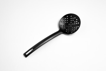 Black plastic Ladle Skimmer isolated on a white background. High-resolution photo.Top view