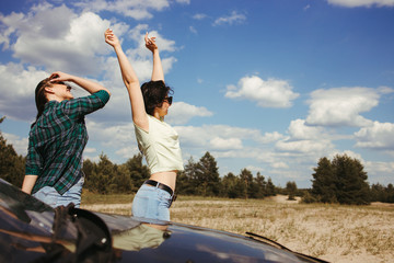 Fototapeta na wymiar Young joyful women enjoy vacation traveling by car. Tourism lifestyle, friendship and travel concept