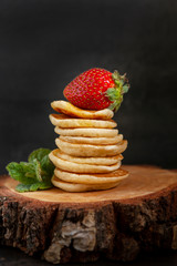 Trendy food during coronavirus Covid-19 lockdown quarantine - tiny pancakes. Poffertjes, Little Dutch pancakes. Breakfast for kids, mini pancakes.