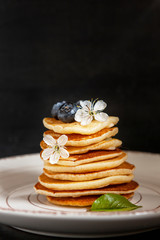Trendy food during coronavirus Covid-19 lockdown quarantine - tiny pancakes. Poffertjes, Little Dutch pancakes. Breakfast for kids, mini pancakes.