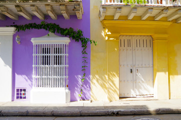 Walking the narrow and colorful streets with historic old buildings with wooden balconies and urban...