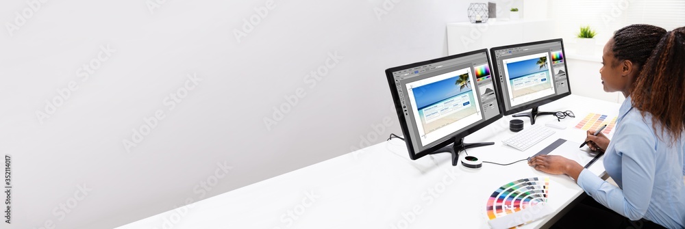 Poster designer editing photos on computer