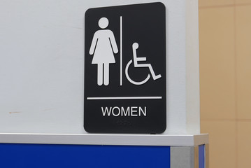 Motion of women and disable washroom logo on wall