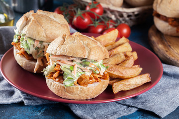 Pulled chicken sandwich with salad and bbq sauce
