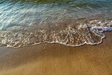 Soft wave of the sea on the sandy beach