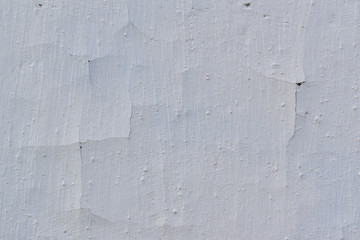 Wall with white old stucco for backdrop. Cracks, swelling, traces of brush strokes.