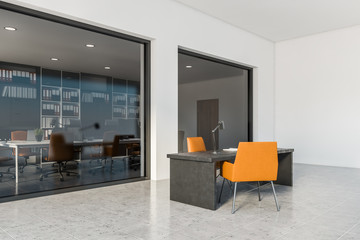 White CEO office corner with orange chairs