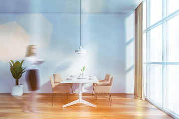 Woman walking in white dining room