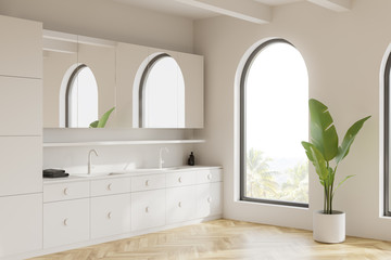 Arched white bathroom corner with double sink