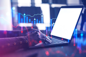 Businesswoman using laptop, falling graph