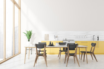 White kitchen interior, yellow countertops, table