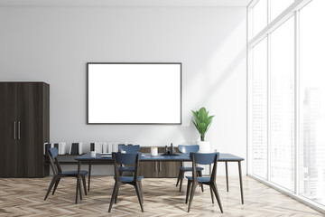 White and wood dining room, bookshelf and poster