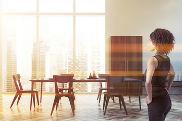 African woman in white dining room