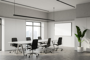 White meeting room corner with poster