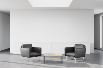 White office waiting room with grey armchairs
