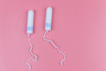 Tampons on a pastel pink background. Top view