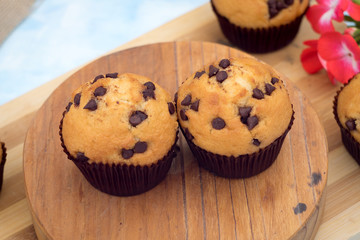 two muffins on a wooden board